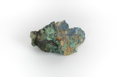 A hand-sized solid mineral specimen in shades of blue, green, and yellow.