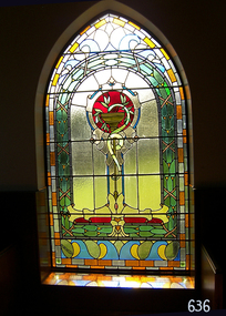 Rectangular arched coloured stained glass window