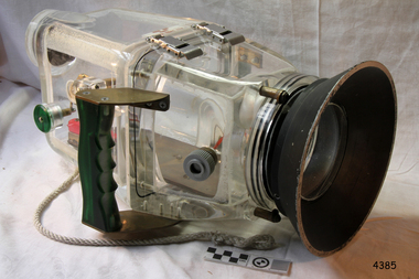 Clear camera housing with plastic and metal components and clip closure