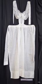 Long white apron with small decorative bib and long ties