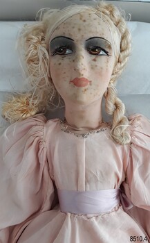 Close up view of the head (with hair and painted face) and bodice of a Boudoir Doll.