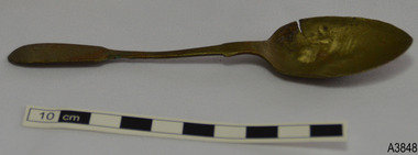 Spoon is discoloured to brown, has a cut in the bowl and is dented