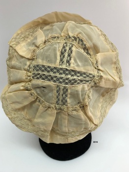Back view of pale yellow silk boudior cap.