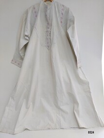 A long, white, lady's cotton nightgown decorated with pintucks and broderie anglaise