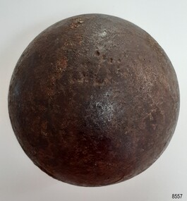 Round black ball with shiny surface damaged by pitting
