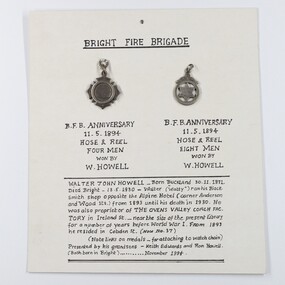 medals attached to a hand written card, not known
