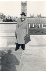 Photograph - black and white, Frank Wright standing in front of the Houses of Parliament  in  London