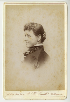 A black and white portrait of an unknown woman taken by John William Lindt. Reverse shows location of John Lindt's studio, his special publications and his various awards and diplomas and the places he won them. Shows also a view of Melbourne, taken by John LIndt.