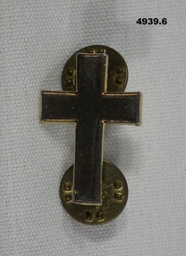 Gold coloured Christian Chaplain's collar badge in the shape of a crucifix.