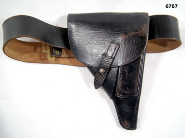 Leather pistol holder with belt.