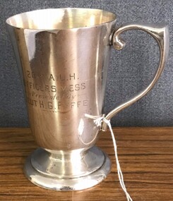 metal drinking cup with engraving on side