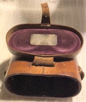 Leather case with metal plaque inside lid