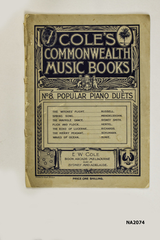 Large buff and dark blue music book with paper cover.
