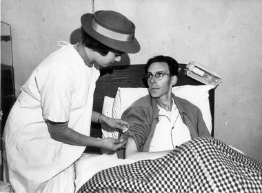 Melbourne District Nursing Society (MDNS) Sister administering an injection
