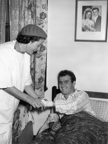 Melbourne District Nursing Service (MDNS) Sister bandaging a gentleman's wrist