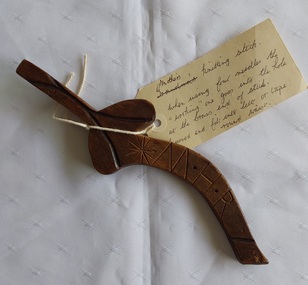 An antique curved carved wooden knitting stick or treen Knitting Sheath for hand knitters.