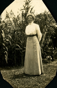 Photograph, Miss Margaret Irving standing in the garden near bamboo circa 1910