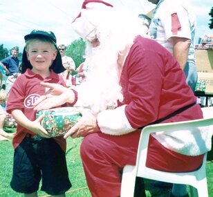 Photograph, Faye Lamb, Christmas picnics at Heidelberg Golf Club - Gift giving, 1990