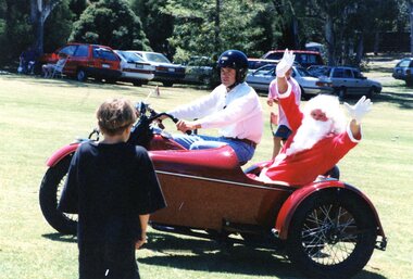 Photograph, Faye Lamb, Christmas picnics at Heidelberg Golf Club - Santa arriving on motorbike, 1990