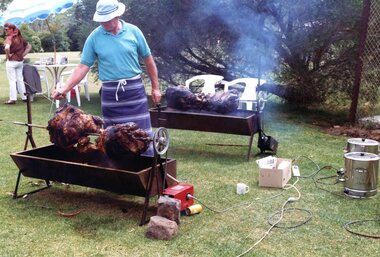 Photograph, Faye Lamb, Picnics at Heidelberg Golf Club - Bill Houghton cooks the spit roast, 1990