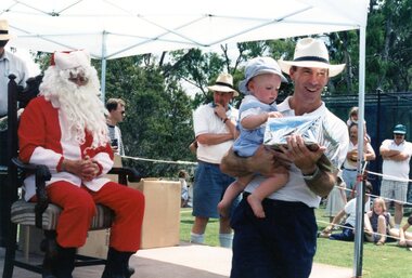 Photograph, Faye Lamb, Christmas picnics at Heidelberg Golf Club - Santa with father and son, 1990