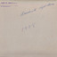 The cream coloured backing of the photo with blue cursive writing and a purple stamp along the top part.