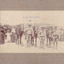 Three soldiers and three horses facing towards camera. Civilians standing in background. Text "H.G Ronald" written on image. Image mounted on card.