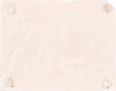 The back of a photograph with sticky residue
