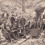 A sepia toned postcard depicting numerous men posing outside of a mineshaft. 