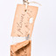 Close up of paper tag tied around leg. 