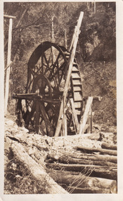 Black and white photograph featuring mining machinery in the center of the photograph