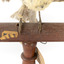 Satin Flycatcher standing on wooden perch facing forward