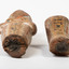 Closeup of the damage to the centre of Ushabti. Both parts (upper and lower) are separated through a break in the centre of the figure and are placed beside each other. 