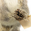 Squirrel standing on a wooden platform and holding a small pinecone with a paper tag tied to one arm.