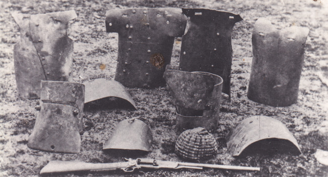 A postcard depicting 10 pieces of Kelly Gang armour and gun, including breast plates and helmets.