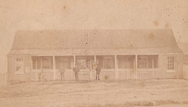 Image of Glenrowan police station on 1 August 1882 with four men standing/sitting out front.