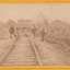 Eight men standing along railway line near Glenrowan