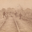 Eight men standing along railway line near Glenrowan