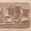 Sepia photograph of Kelly armour including helmets and breastplates arranged on the ground.