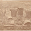 Sepia photograph of the Kelly Gang armour sitting on the ground. A thin border around the main image appears to continue the image in a whiter tone.