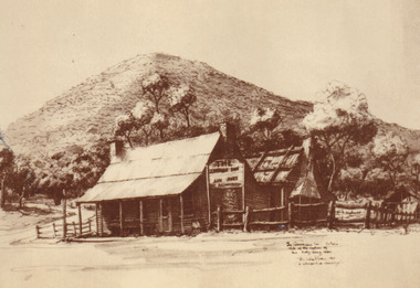 At the foreground of the photo is an inn (made up go 2 houses), surrounded by trees with a large mountain in the background