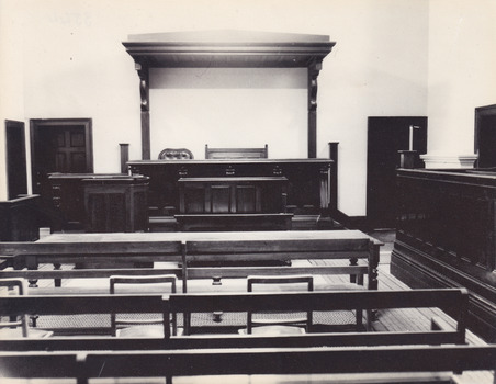 Black and white reproduction of photograph featuring interior of Beechworth Historic Courthouse