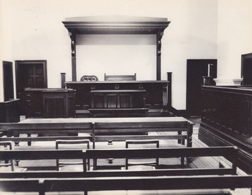 Black and white reproduction of photograph featuring interior of Beechworth Historic Courthouse