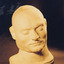 Colour photograph of Ned Kelly’s death mask showing details of the front of his face. The mask is life size and made of plaster.