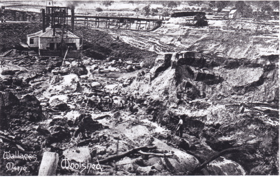 Photograph of mining operations, including buildings, tracks and mines.