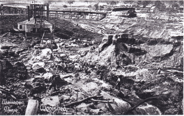 Photograph of mining operations, including buildings, tracks and mines.