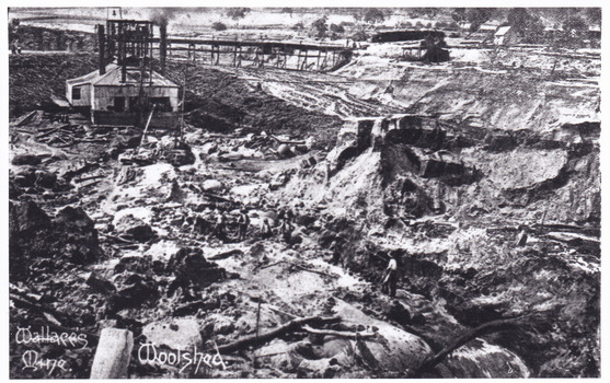 Photograph of mining operations, including buildings, tracks and mines. Cropped image
