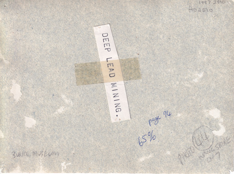 Rear of an aged photograph. The colour is grey with some tears in it.