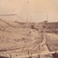 Image taken at Allan's flat at one of J.A. Wallace's barge sites. Image depicts water-race and pipes along the ground, connected to two small buildings on high ground.