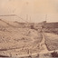 Image taken at Allan's flat at one of J.A. Wallace's barge sites. Image depicts water-race and pipes along the ground, connected to two small buildings on high ground.